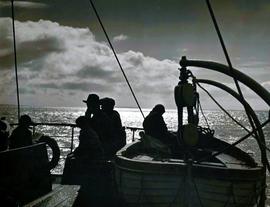 Scene on a ship leaving the Aran Islands at sunset