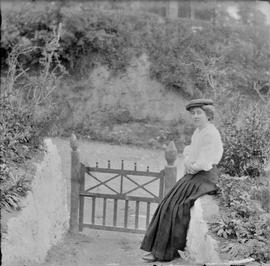 Woman outside a roadside cottage