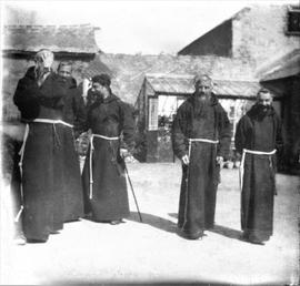 Capuchin Friars walking in a walled garden